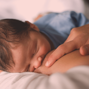 Top view of a baby sucking on mother's breast