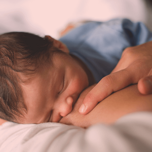 Top view of a baby sucking on mother's breast